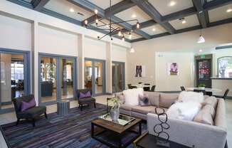 A living room with a grey couch and a coffee table.