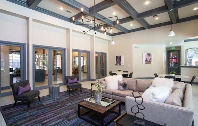 A living room with a grey couch and a coffee table.