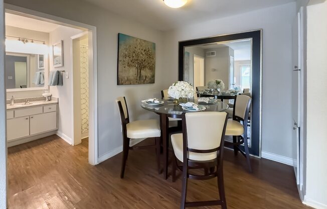 a dining room with a table and chairs