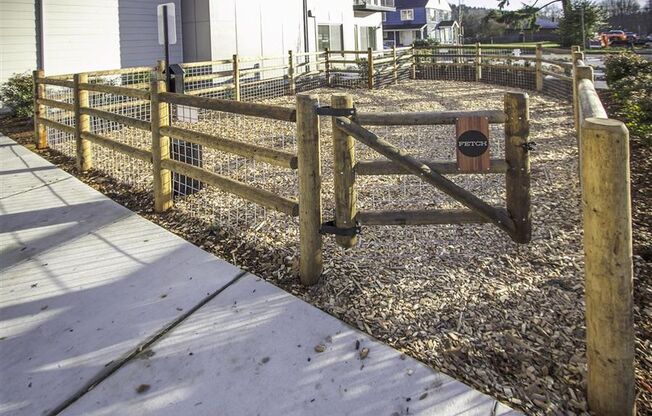 a wooden fence with a sign on it in a yard