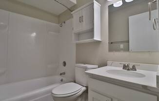 a bathroom with a sink toilet and a bath tub