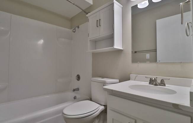 a bathroom with a sink toilet and a bath tub