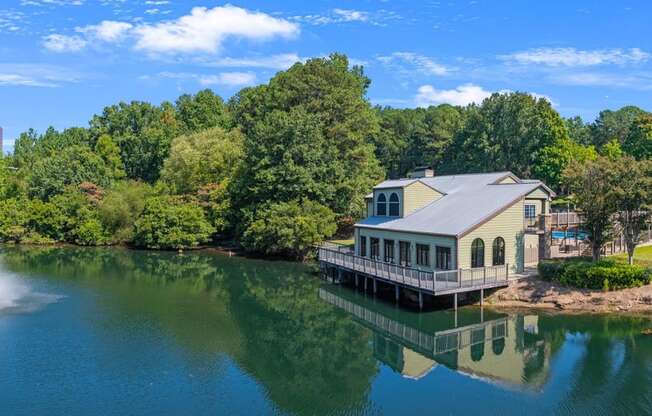 a house on the water with a fountain