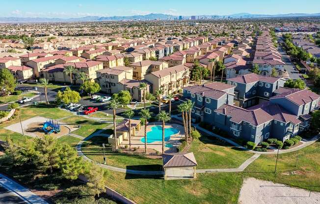 an aerial view of a neighborhood with houses and a swimming pool