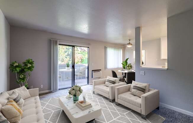 A living room with a white couch, a coffee table, and a mirror on the wall.