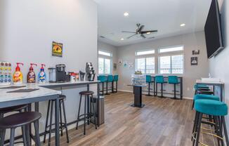 a kitchen with a table and chairs in a room