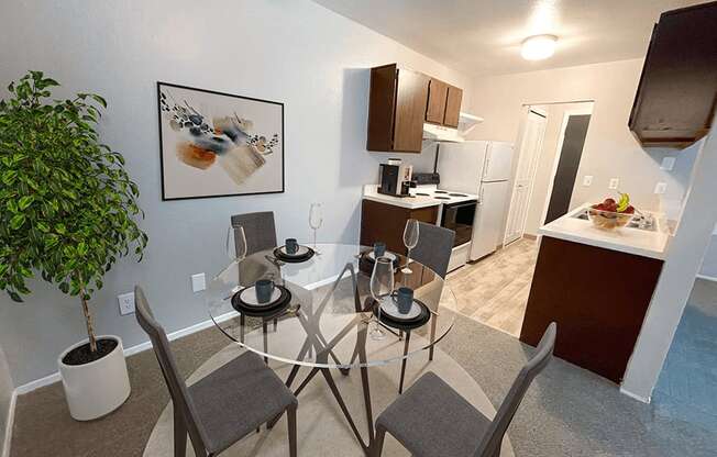 a kitchen and dining room with a glass table and chairs