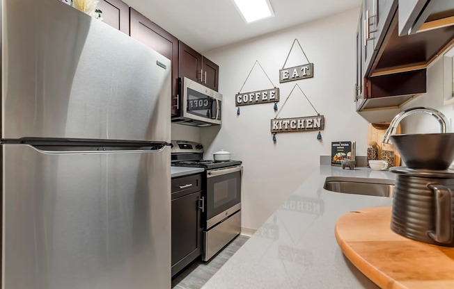 a kitchen with stainless steel appliances and black cabinets