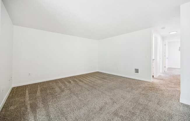 A room with a carpeted floor and white walls.