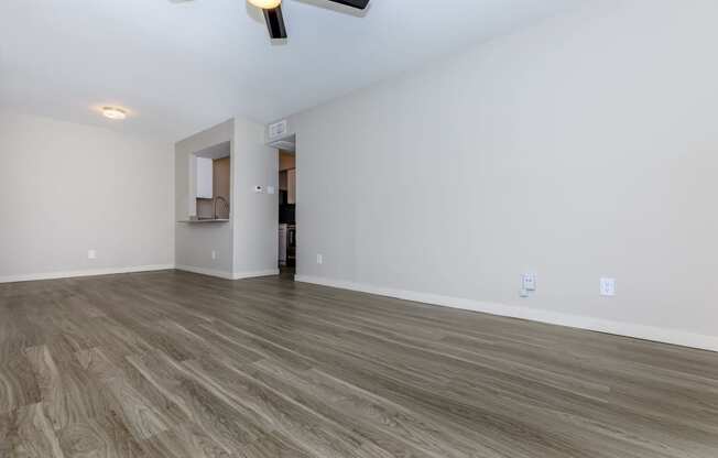 a bedroom with a ceiling fan and hardwood floors