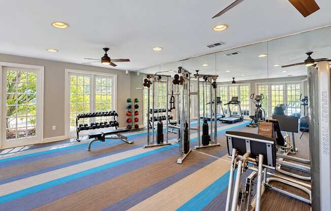 Fitness center with dumbbells, a weight bench, cable equipment, and a mirrored wall at Elevation 3505 in Atlanta, GA.