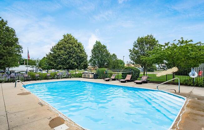 A pool with a no diving sign in the foreground.