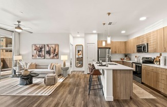 A modern kitchen with a dining area and a living room.