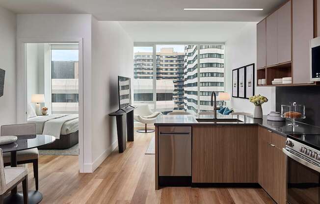 A modern kitchen with wooden floors and furniture.