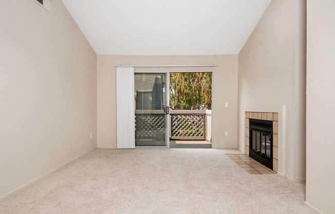 Carpeted Living Room with Fireplace and Balcony