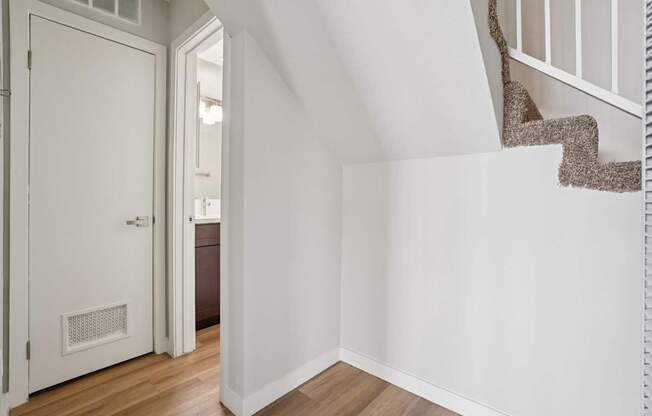 A white door is open to a hallway.