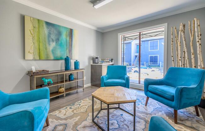 a living room filled with furniture and a blue chair