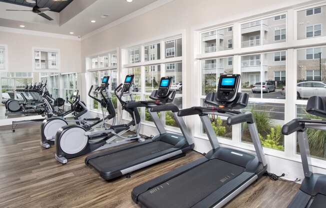 Premium fitness center with treadmills, bikes, and rowing machines at at the Station at Savannah Quarters in Pooler, GA