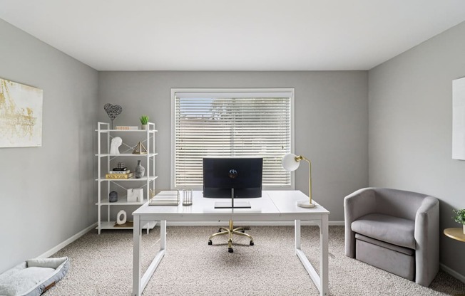 Home office setup with desk, chair, and shelving at Ashford at Geneva Apartments – pet-friendly rentals near the Far Northwest Chicago Suburbs