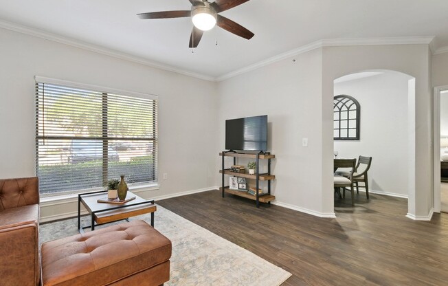 A living room with a brown leather chair and a wooden coffee table.