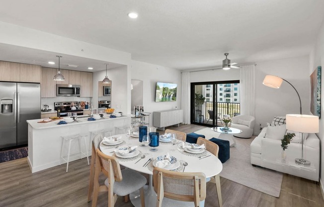 a living room and kitchen with a table and chairs at Altis Santa Barbara, Naples, 34104