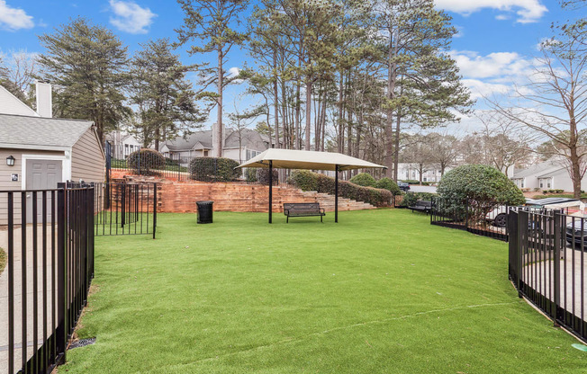 a backyard with a lawn and a gazebo