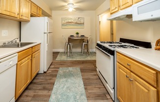 a kitchen with white appliances and wooden cabinets