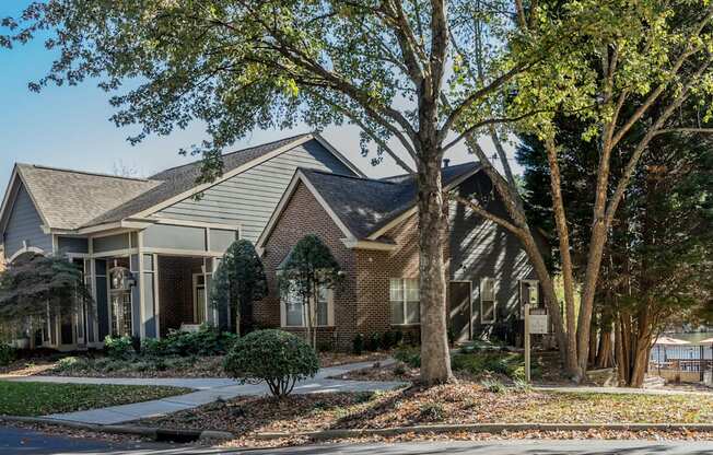 an apartment building with a yard and trees in front of it at Radbourne Lake Apartments, North Carolina ? 