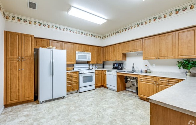 a kitchen with white appliances and wooden cabinets