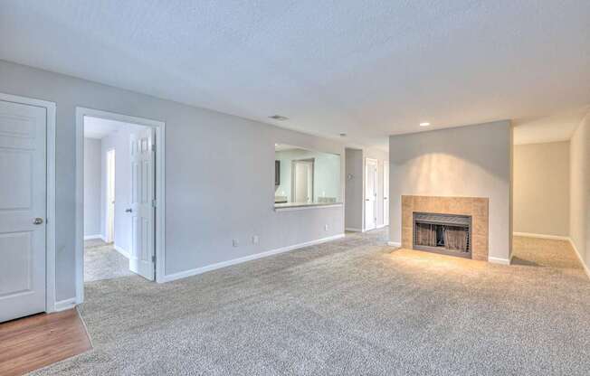 A spacious living room with a fireplace and a carpeted floor at Landmark at Lyncrest Reserve Apartments, Tennessee 37209