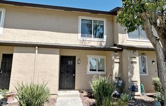 Move-in ready Evergreen townhome with private backyard, detached 2-car garage, and great community amenities
