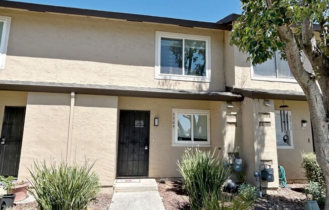 Move-in ready Evergreen townhome with private backyard, detached 2-car garage, and great community amenities