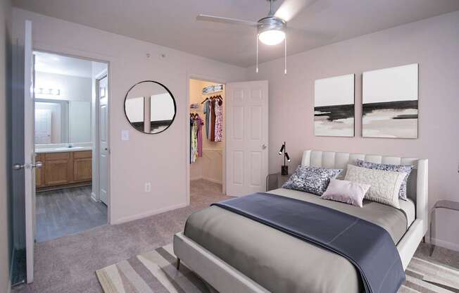 A bedroom with a bed, a dresser, and a mirror.