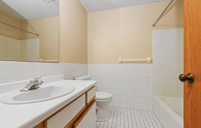 a bathroom with a sink toilet and a bath tub. Anoka, MN Dellwood Estates