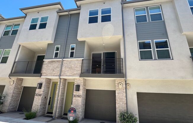 New 1 bedroom townhouse with loft/office space and attached garage in Civita!