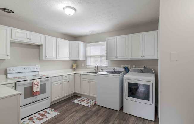 a white kitchen with white appliances and white cabinets at Fay Street Apartments, Winchester Virginia