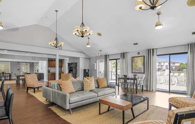 a living room with a couch and chairs and a fireplace