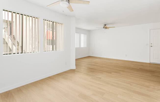 A room with wooden floors and a ceiling fan.