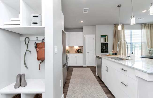 a renovated kitchen with white cabinets and a counter top and a sink