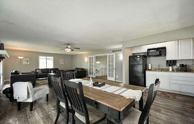 A modern kitchen with a dining table and chairs.