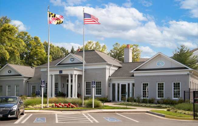 a large gray building with two flags in front of it