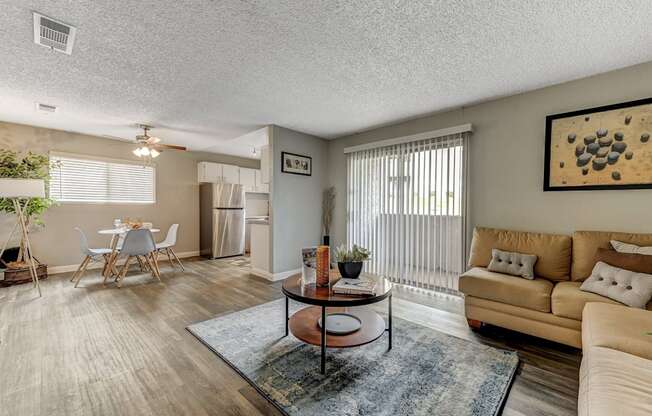 a living room with a couch and a table and a kitchen at Desert Bay Apartments, Laughlin,89029