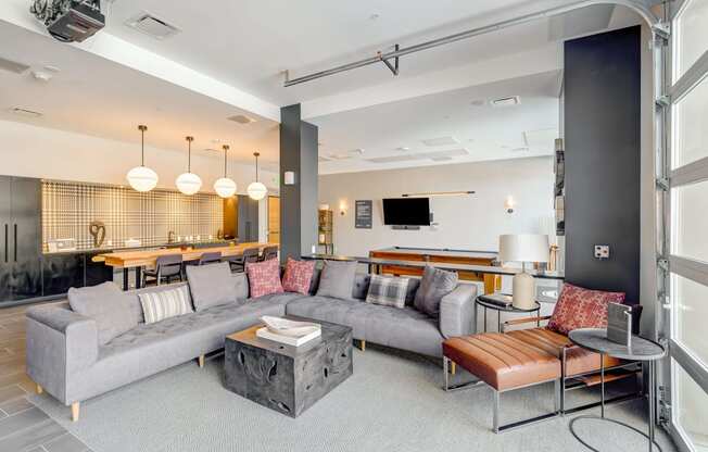 a living room filled with furniture and a large window