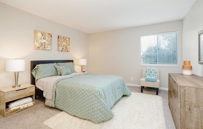 Primary bedroom with large windows and en-suite bathroom at Malibu at Martin Apartments in Huntsville, Alabama
