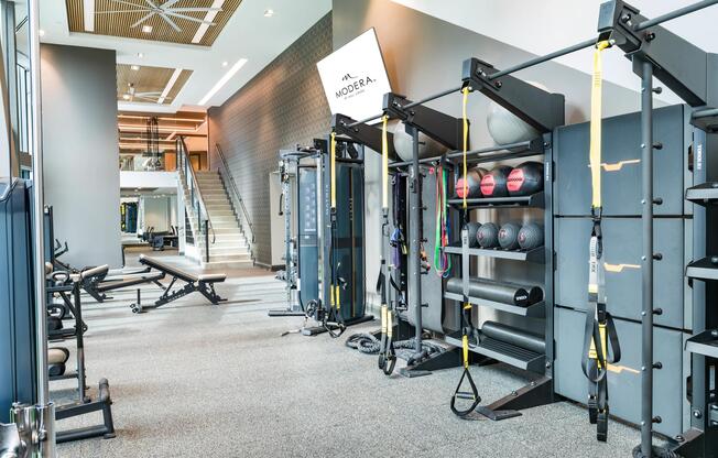 An advanced fitness center at Modera McGavock, featuring strength and functional training spaces.