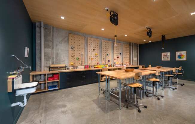 a dining room with tables and chairs and a wall with magnets on it at The Audubon New Haven, New Haven, CT, 06511