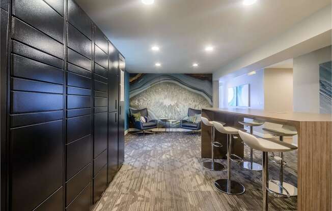 A room with a bar and stools.