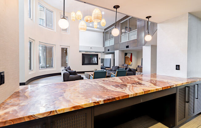 a large kitchen with a counter top and a living room