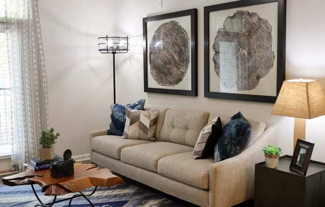 a living room with a couch and pictures on the wall
