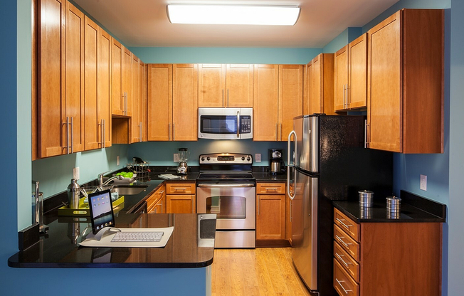 Contemporary Kitchen With Granite Countertops, Wood Cabinets & Stainless Steel Appliances